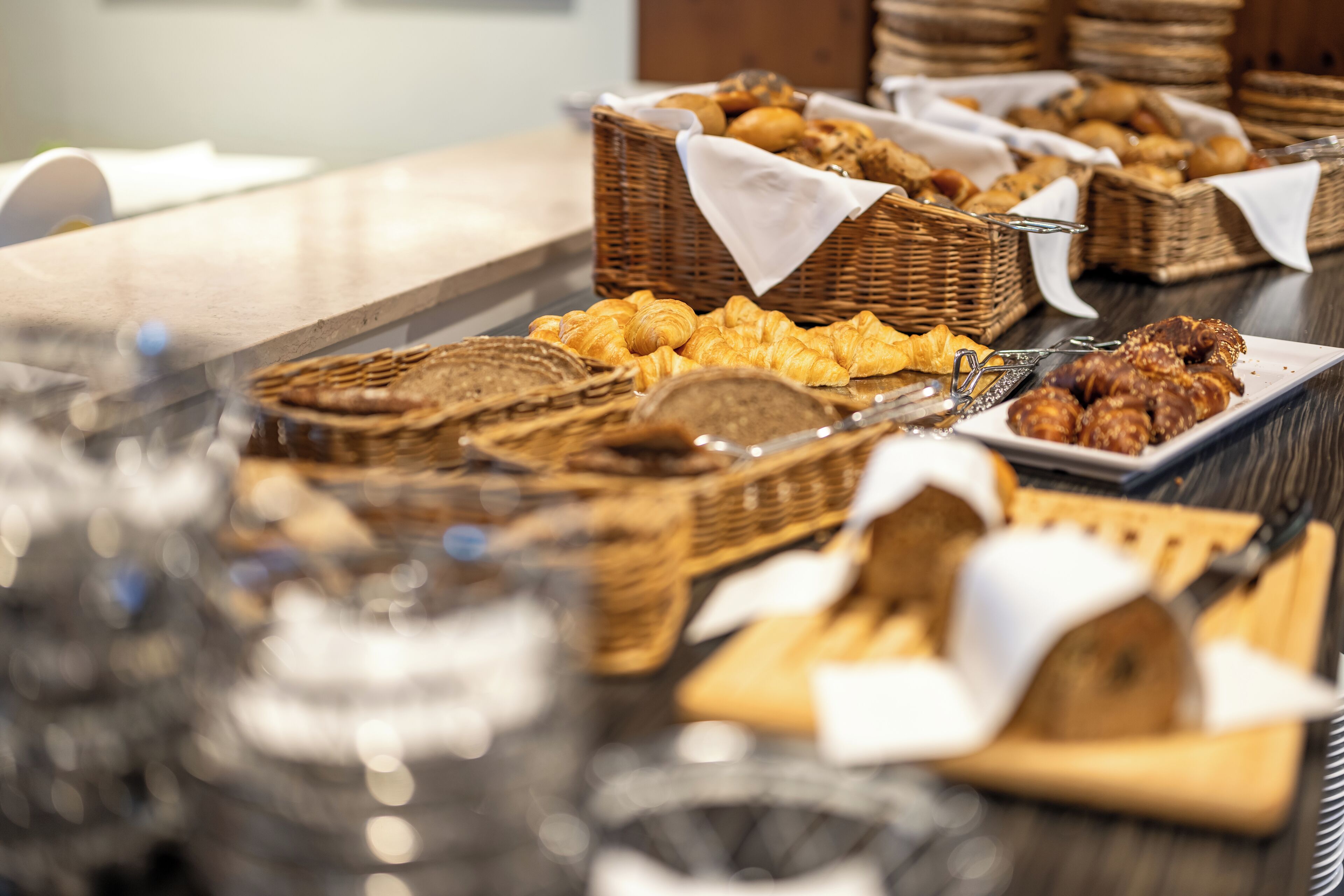 A buffet table with various baked goods and pastries.