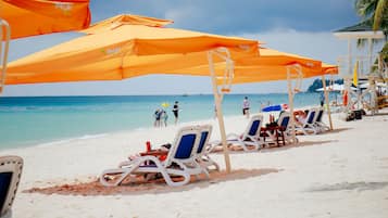 On the beach, white sand, beach umbrellas, beach towels