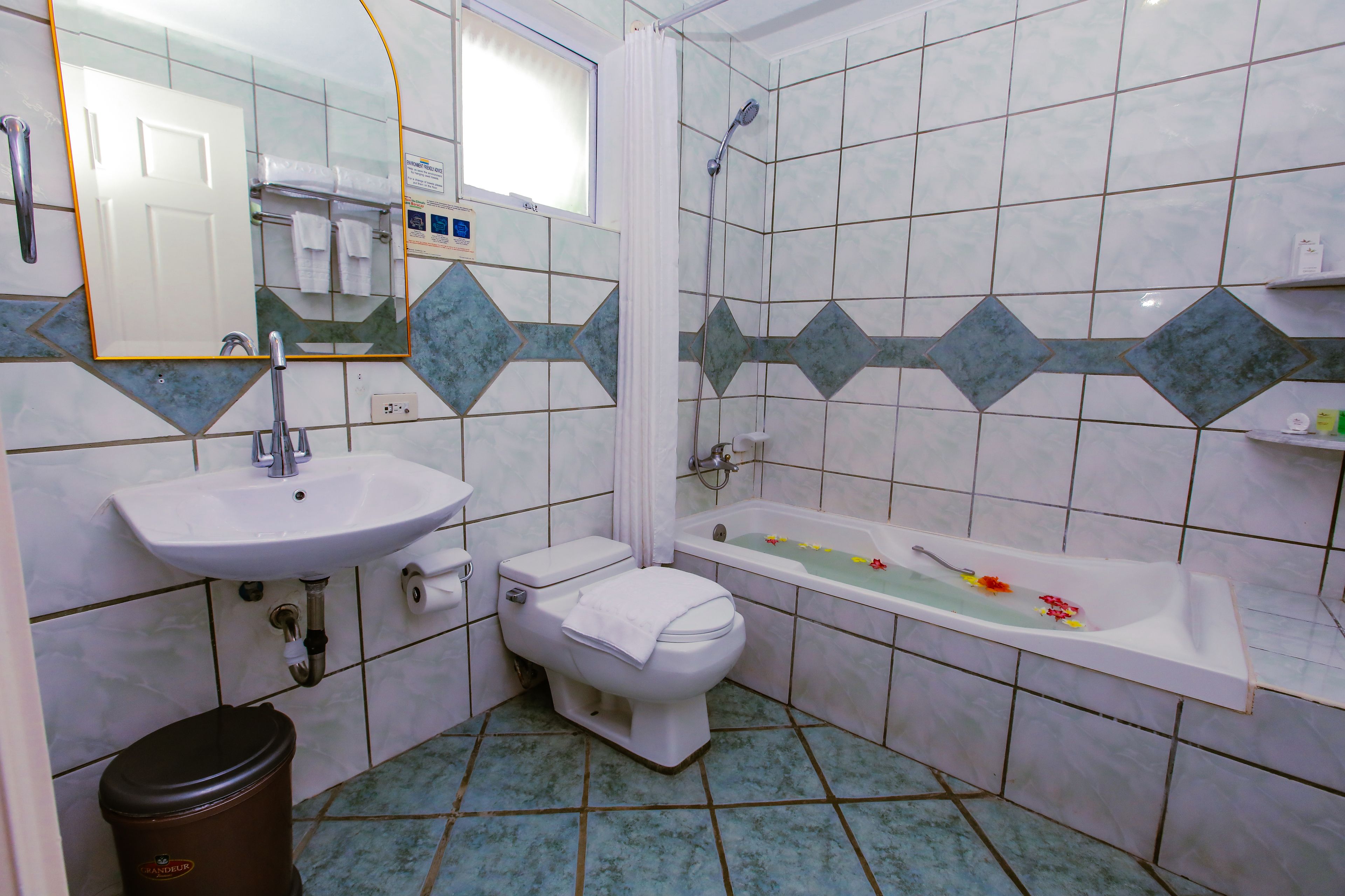 A bathroom with a sink, toilet, and bathtub.