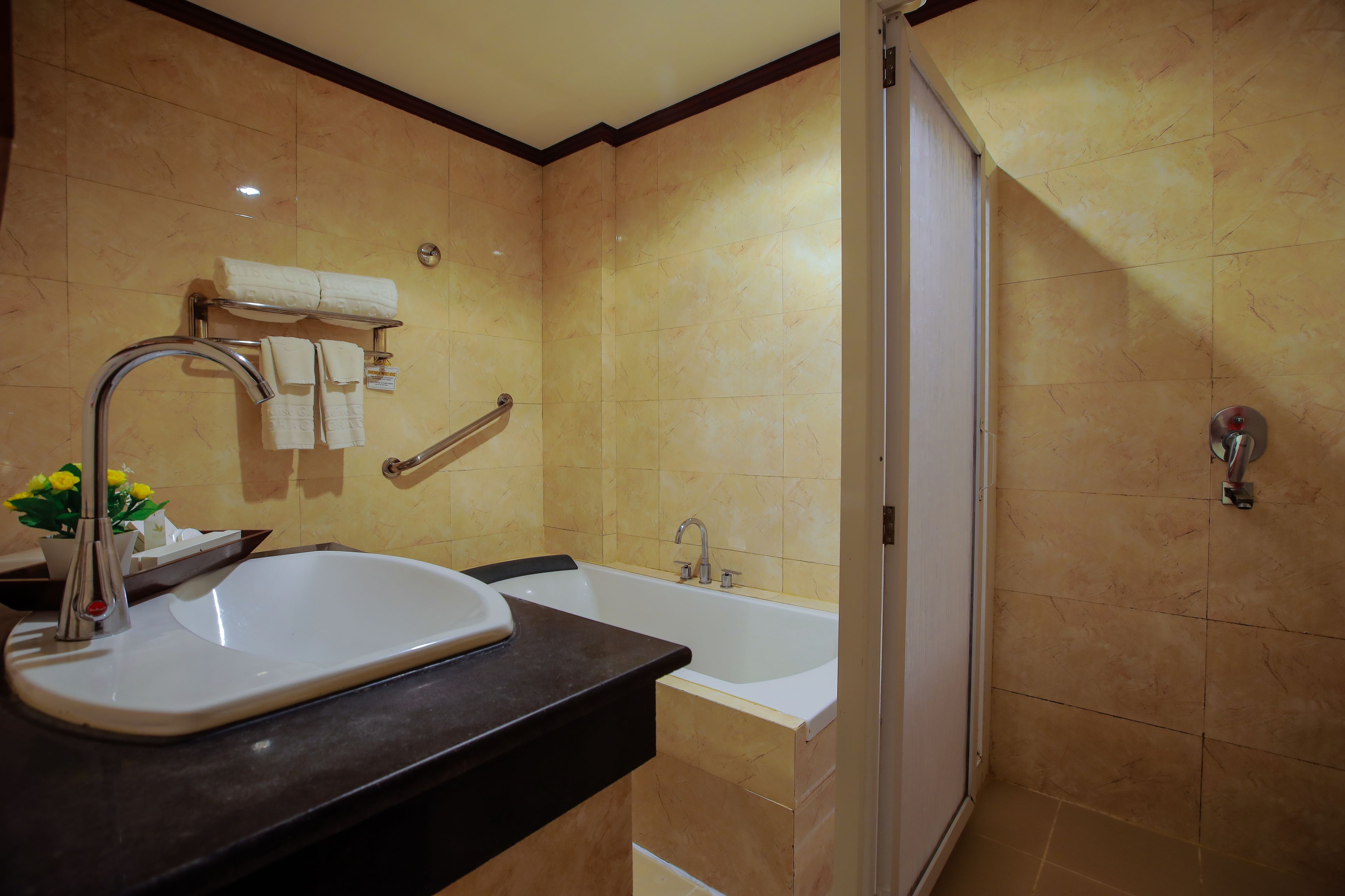 A bathroom with a sink, bathtub, and shower.