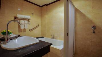 A bathroom with a sink, bathtub, and shower.