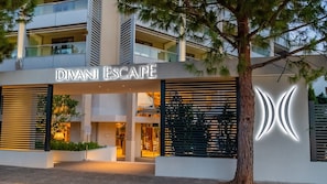 A modern building with the sign 'DIVANI ESCAPE' indicating a hotel or resort. - Divani Escape- Adults only (Vari-Voula-Vouliagmeni)