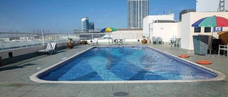 Outdoor pool, pool umbrellas, sun loungers