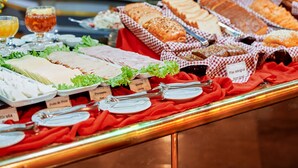Monipuolinen buffet, jossa on tarjolla erilaisia ruokia ja juomia.