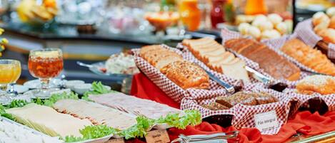 A buffet with various food items and beverages.