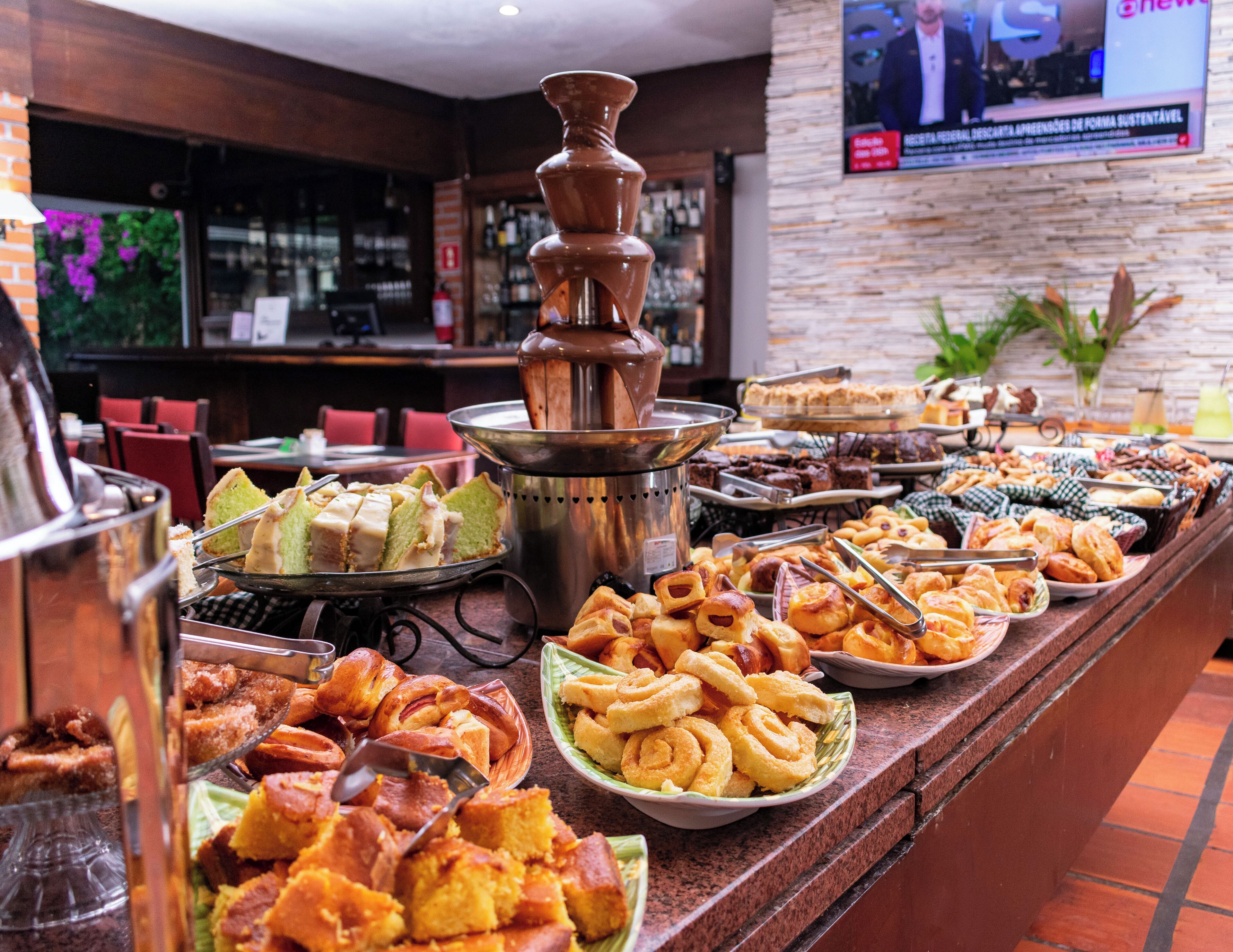A buffet with various baked goods and pastries.