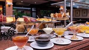 A buffet with various desserts and beverages.