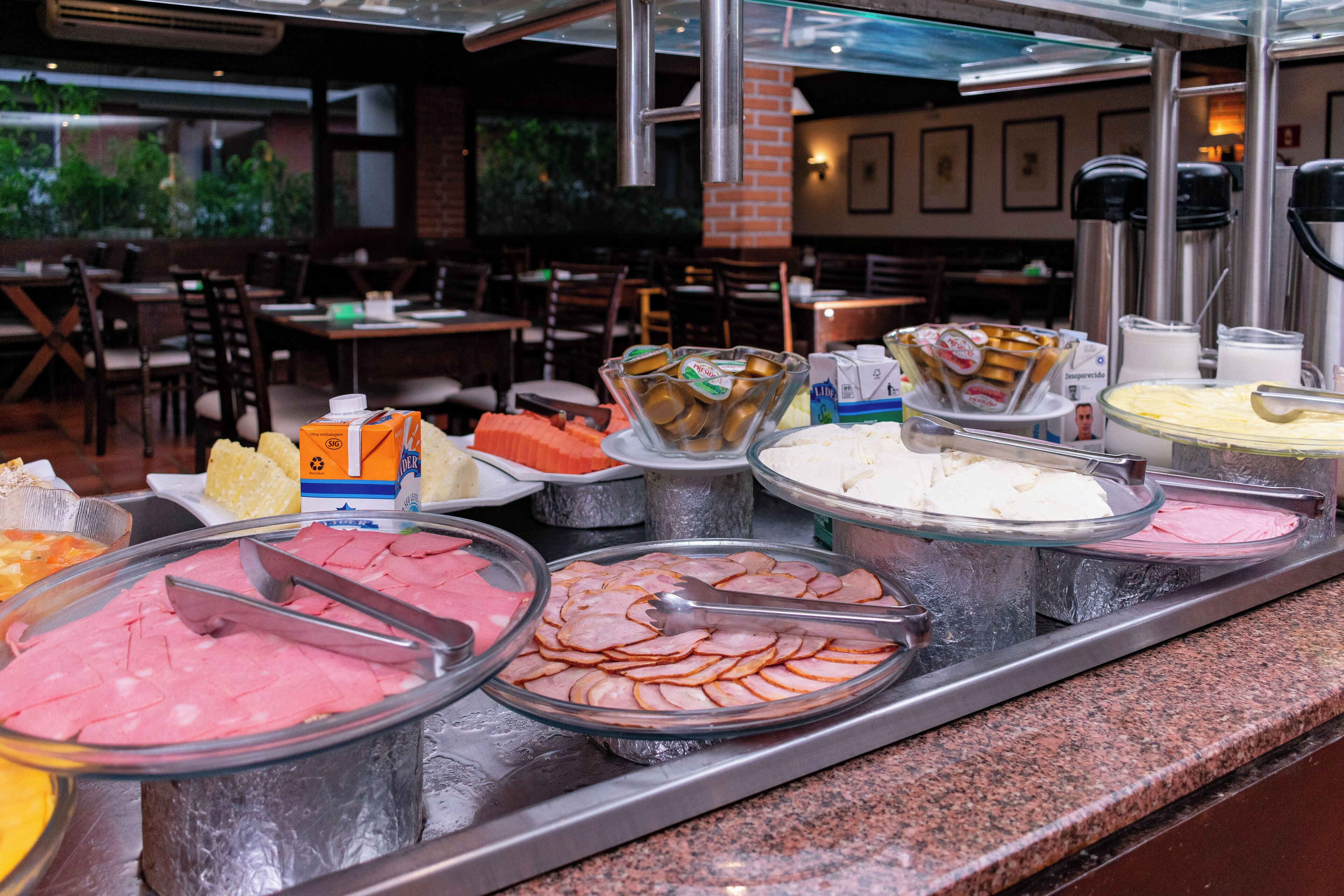 A buffet with various food items and condiments.