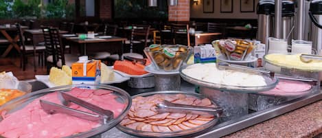 A buffet with various food items and condiments.