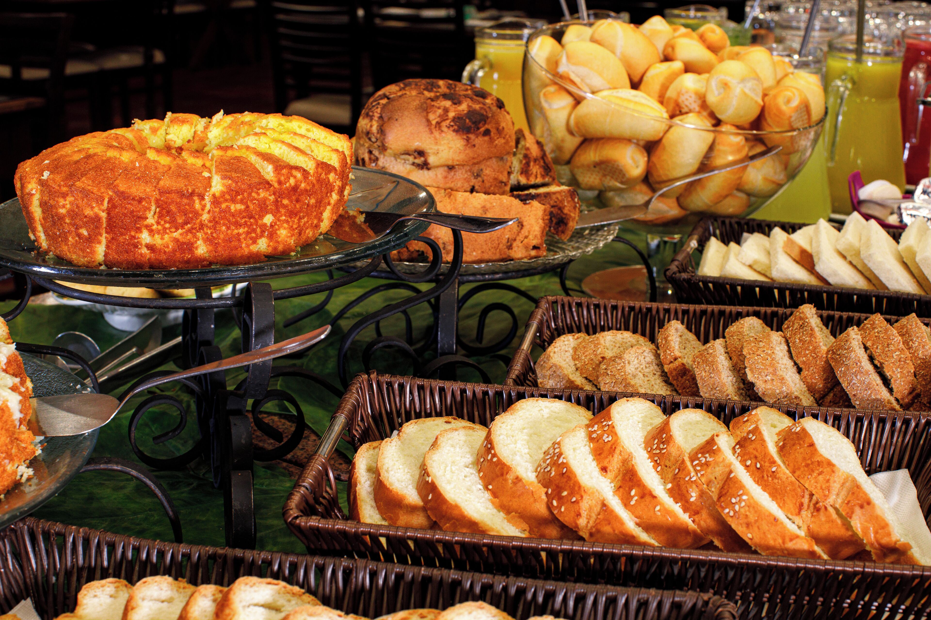 A buffet with various baked goods and beverages.
