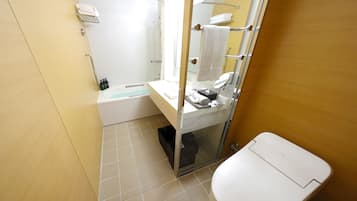 A modern bathroom with a bathtub, toilet, and a glass shower enclosure.