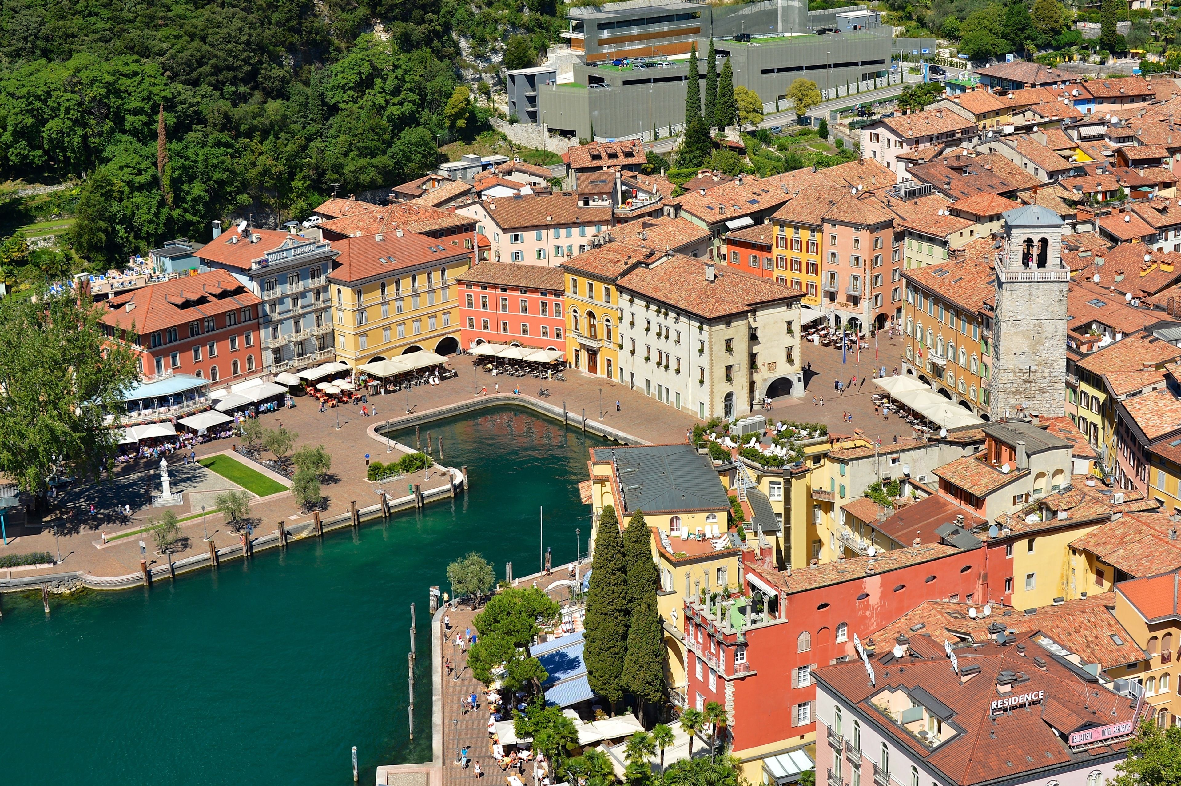 A historic town with colorful buildings, a central square, and a waterfront.
