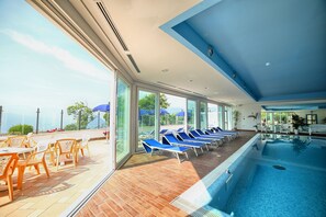 Indoor pool, pool umbrellas, pool loungers