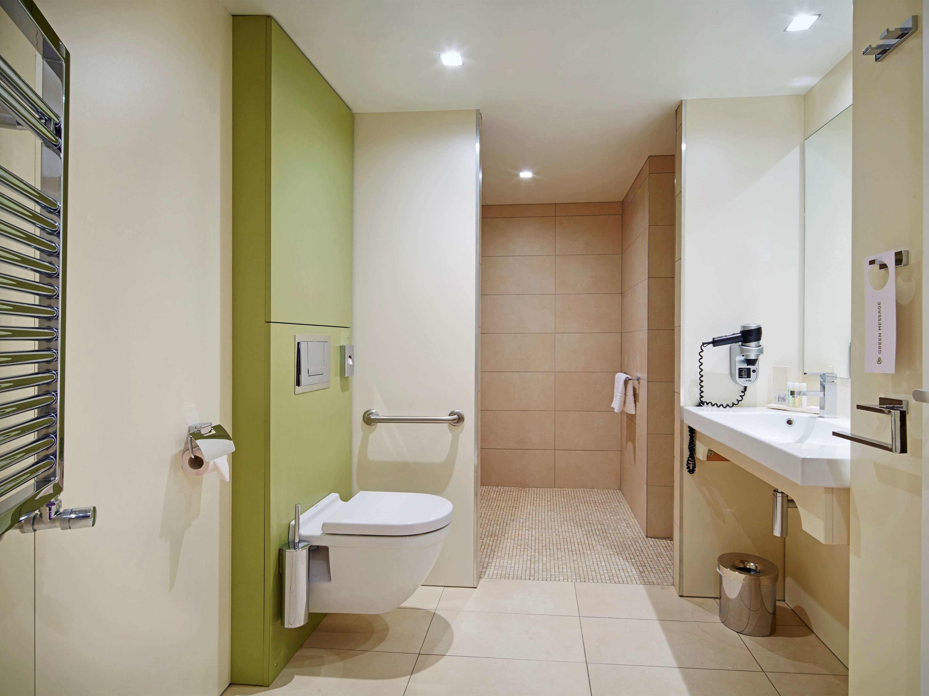 A modern bathroom with a toilet, bidet, and sink.