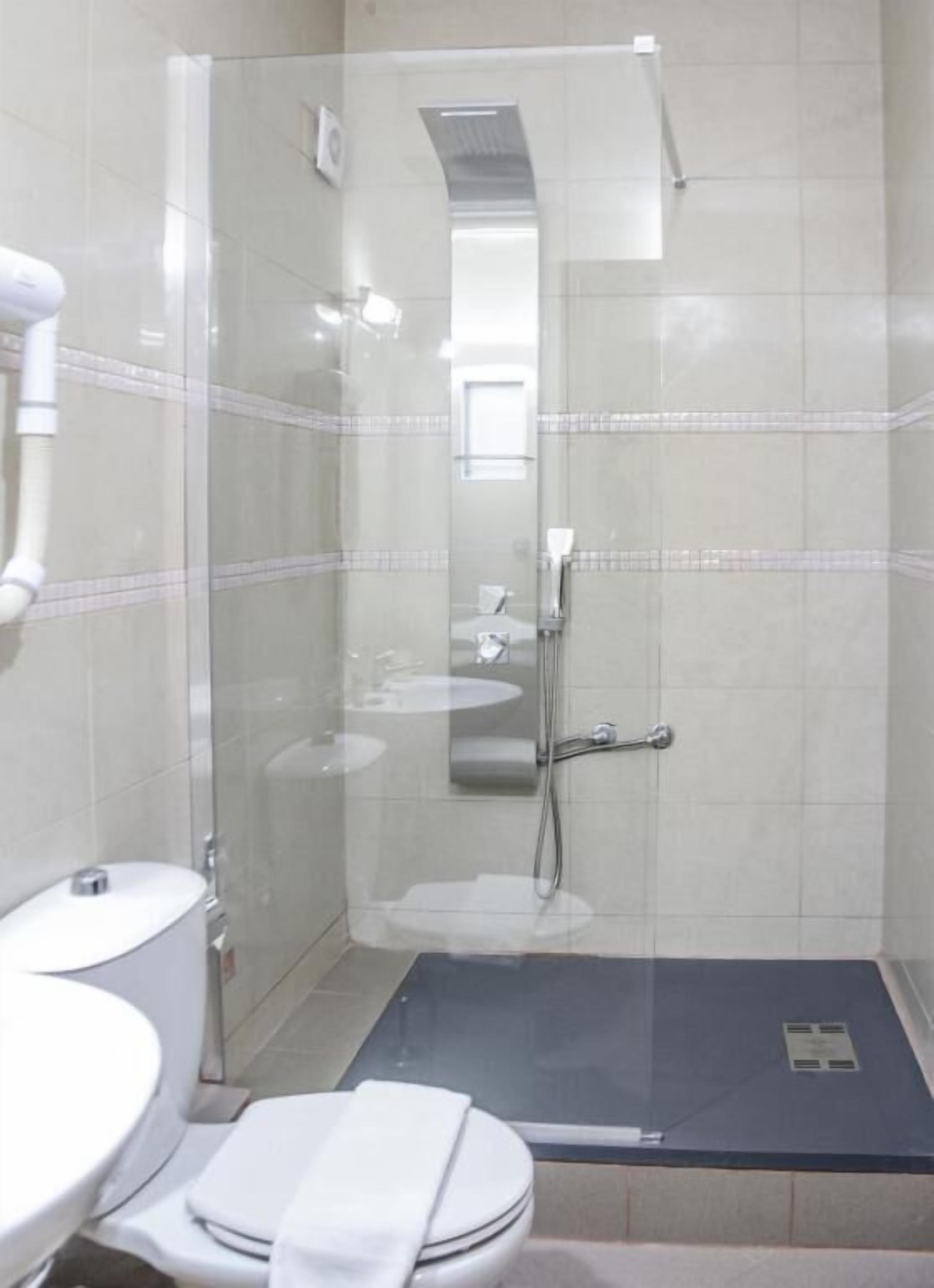 designer toiletries, hair dryer, slippers, towels