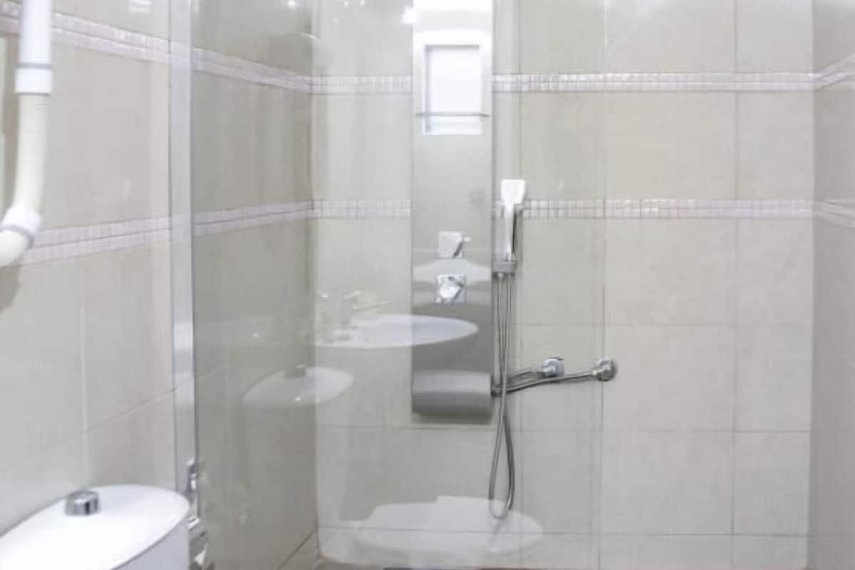 designer toiletries, hair dryer, slippers, towels