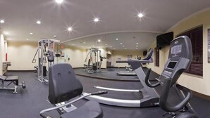 A gym with treadmills, weight machines, and a mirrored wall. - Holiday Inn Express & Suites Houston West - Katy by IHG (Katy)