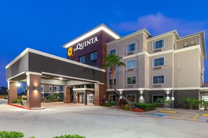 A multi-story hotel with a prominent 'La Quinta' sign, a covered entrance, and a parking area with handicapped accessibility. - La Quinta Inn & Suites by Wyndham Houston Channelview (Houston)