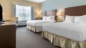 A hotel room with two beds, a desk with a computer, a chair, and a window with curtains. - Best Western Plus Liverpool Hotel & Conference Centre (Brooklyn)