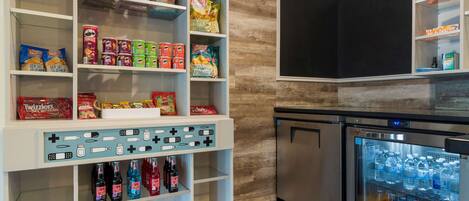 A snack and beverage display area with various packaged snacks and bottled drinks.