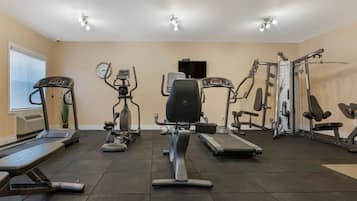 A gym with treadmills, elliptical machines, and weight machines.