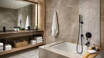 A modern bathroom with a large mirror, a bathtub, and a shower.