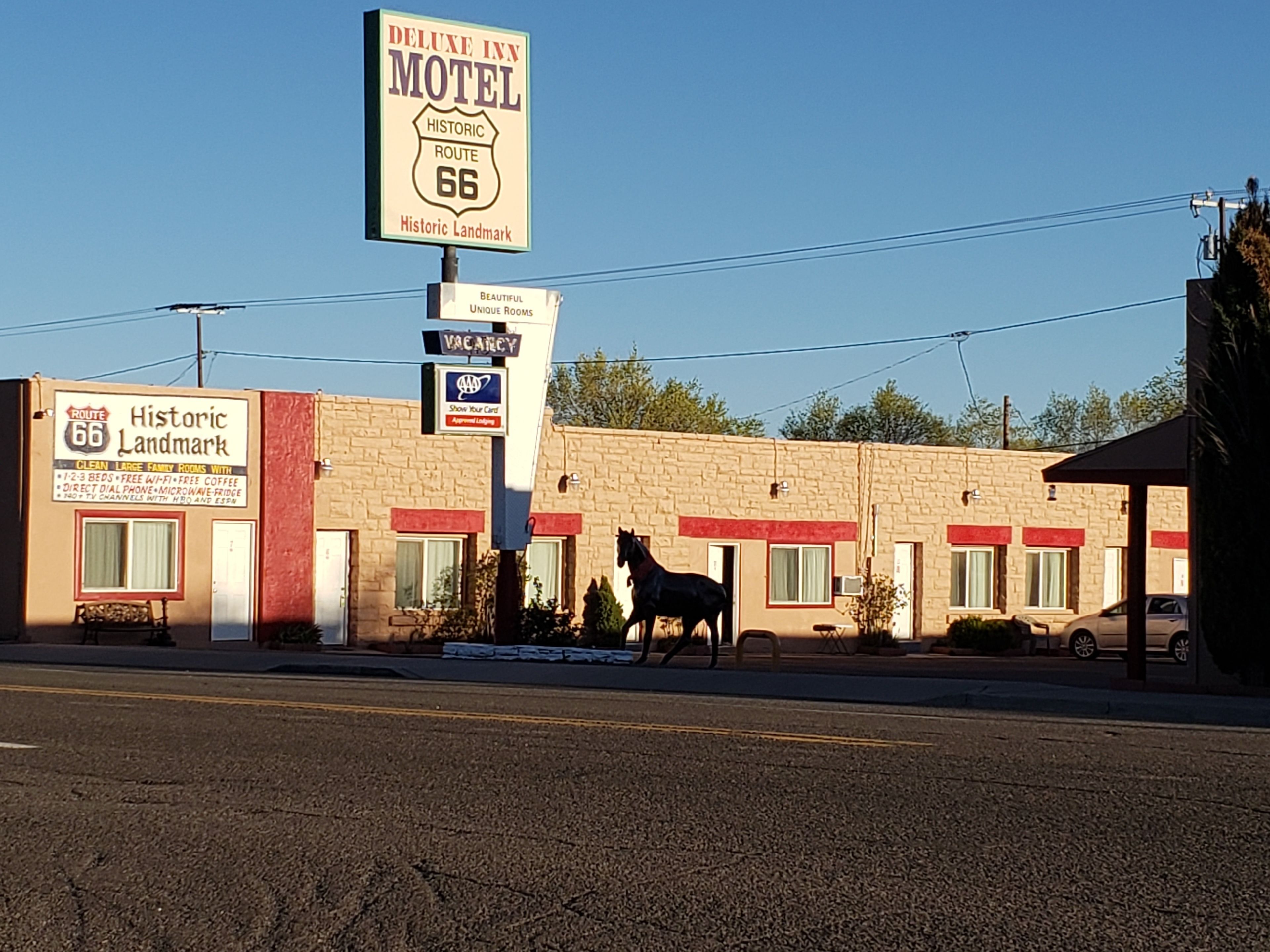A motel with a sign indicating it is a historic landmark on Route 66.