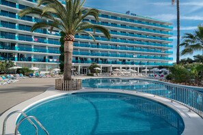A hotel with a large pool, multiple balconies, and sun loungers. - Hotel THB Sa Coma Platja (Sant Llorenc des Cardassar)