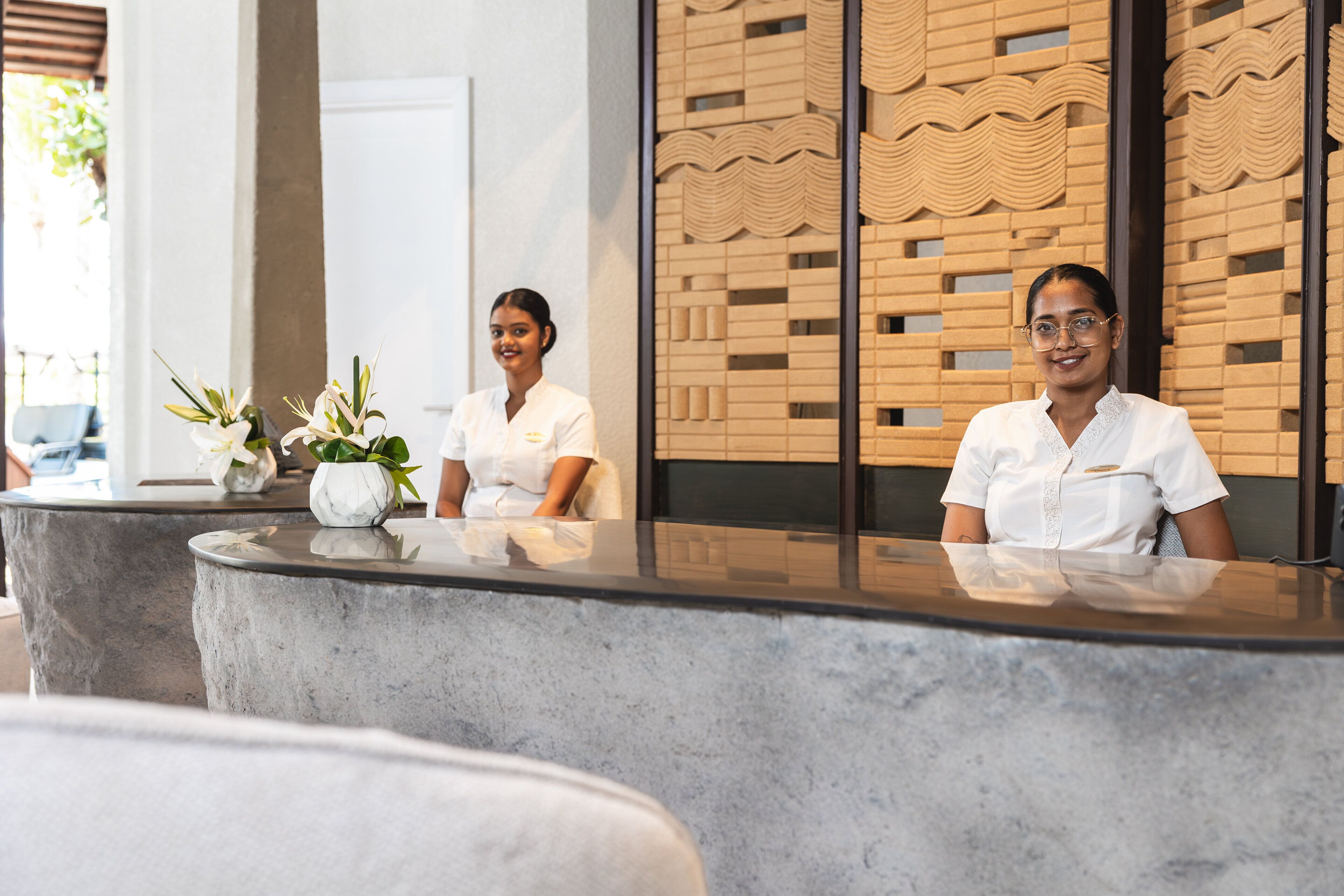 A reception desk with two staff members seated.
