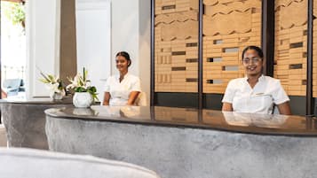 A reception desk with two staff members seated.