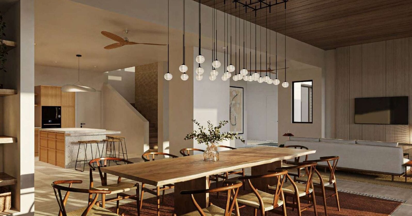 A modern dining area with a wooden table and chairs, hanging spherical light fixtures, and a kitchen in the background.