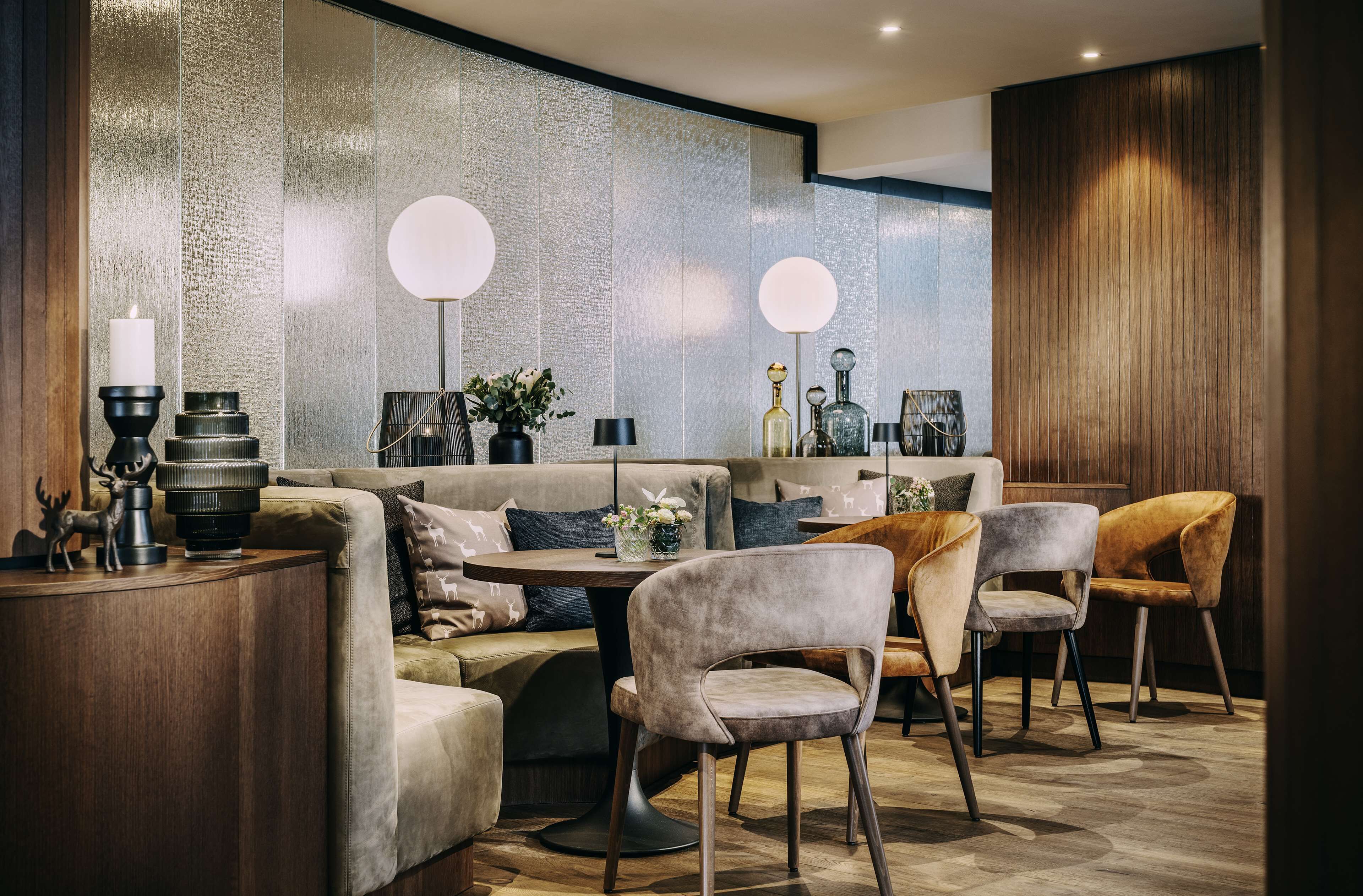 A modern interior with a sofa, chairs, a table, and decorative items.