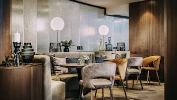 A modern interior with a sofa, chairs, a table, and decorative items.