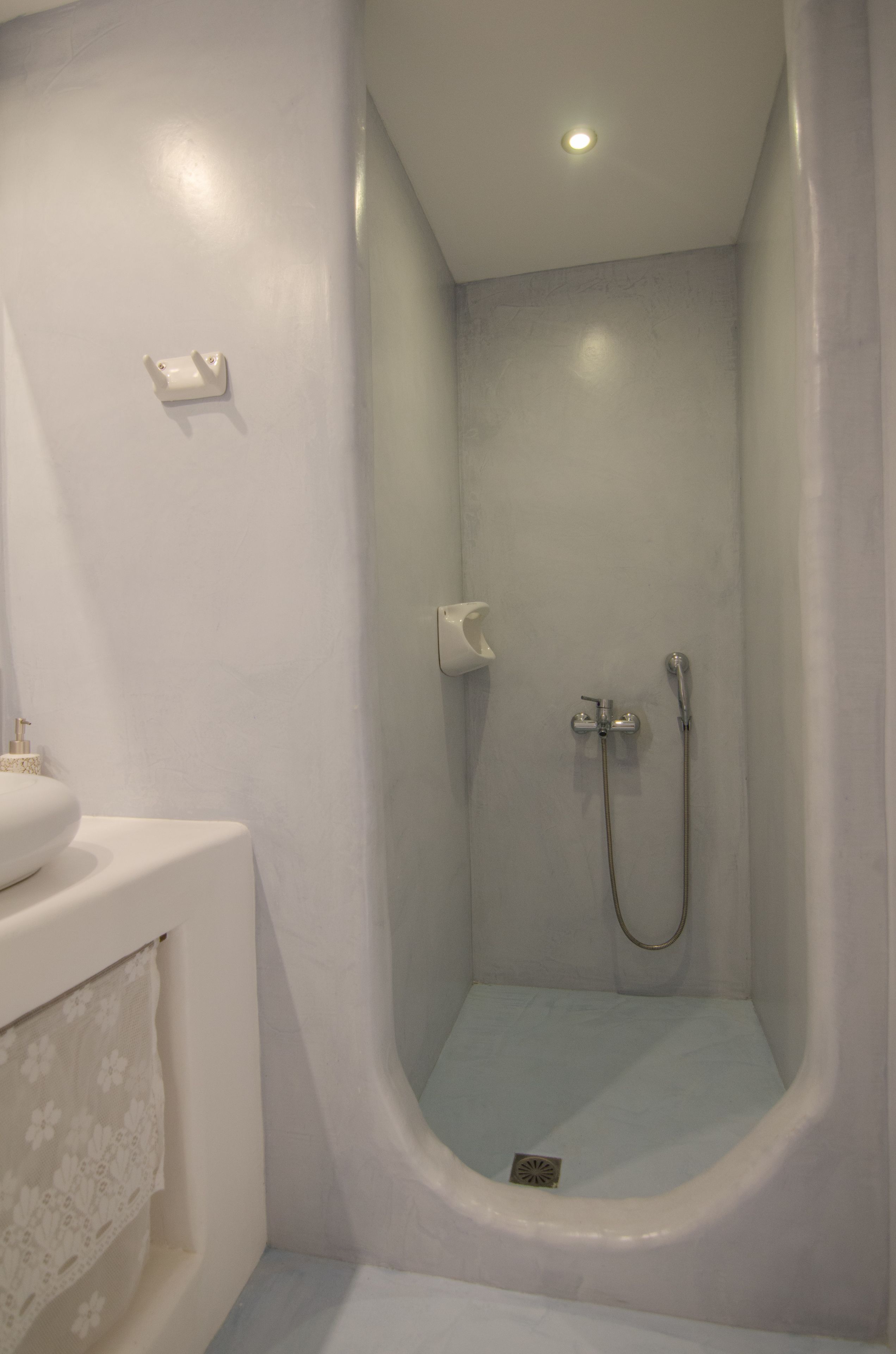 A modern bathroom with a freestanding bathtub, a toilet, and a sink.