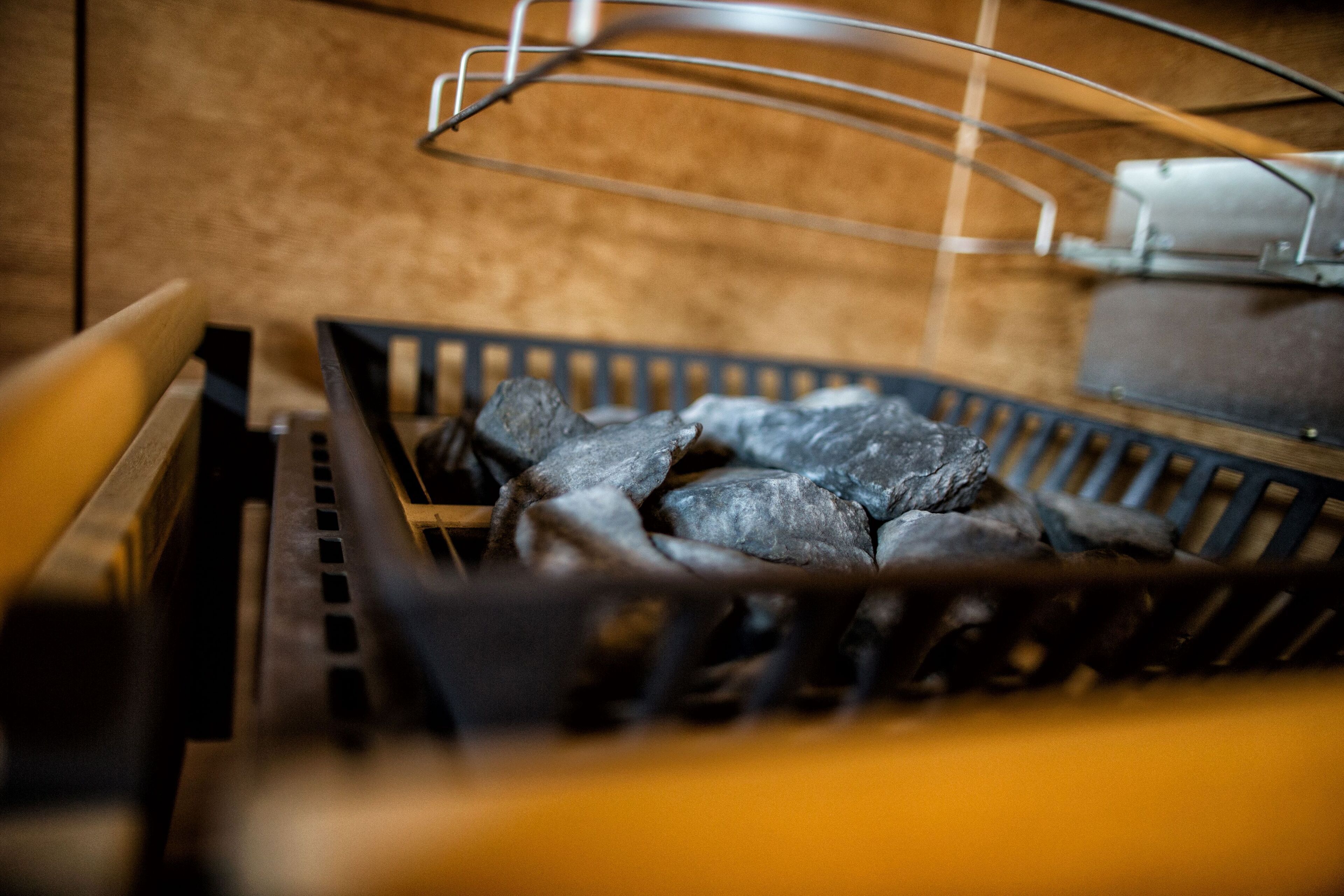A grill with charcoal and metal grates.