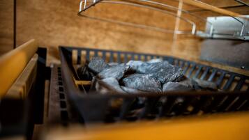 A grill with charcoal and metal grates.