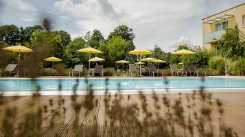 Alberca al aire libre por temporada y sombrillas en la alberca