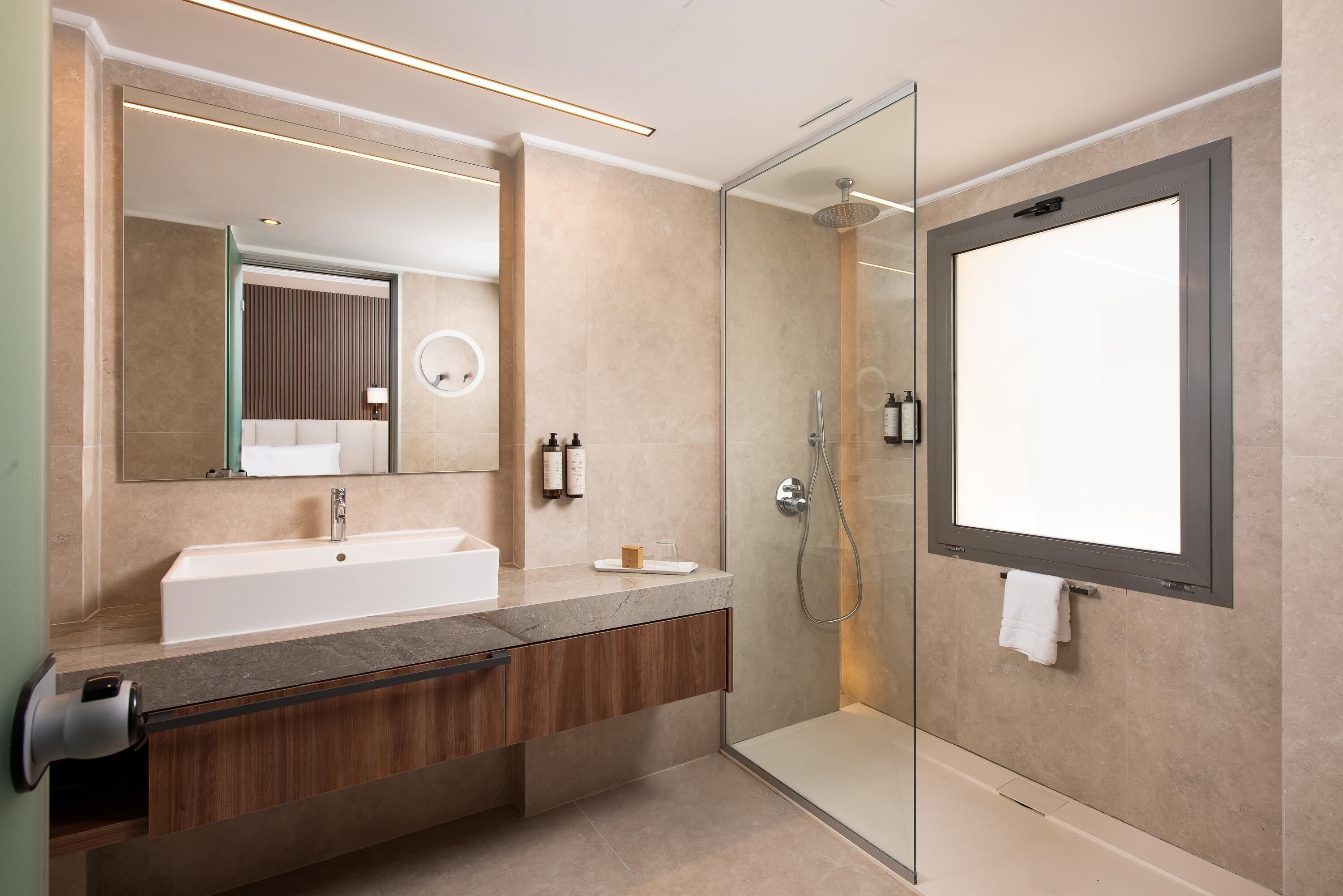 Junior Suite, Sea View | Bathroom | Eco-friendly toiletries, hair dryer, bathrobes, slippers