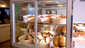 A bakery display case with various breads and pastries. - Zagreb Hotel (Istanbul)