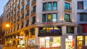 A multi-story hotel with a classic architectural design, featuring balconies and large windows. - Zagreb Hotel (Istanbul)