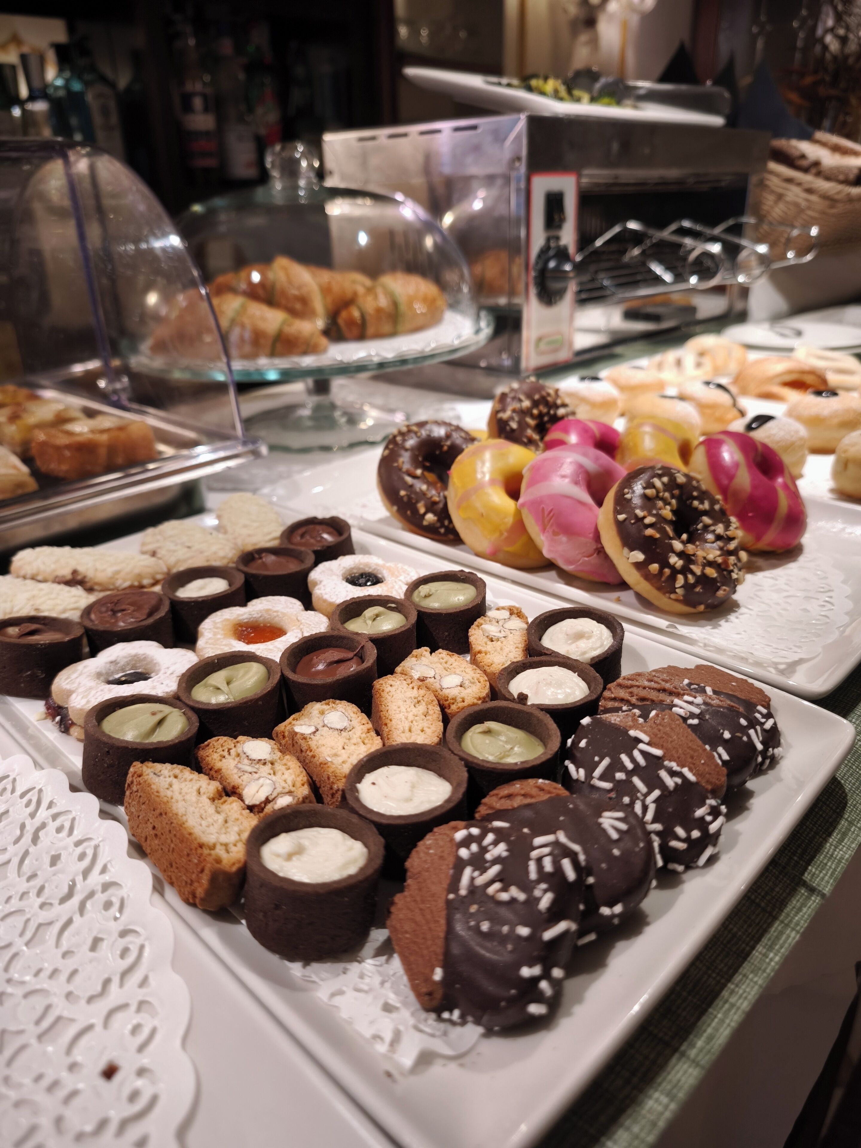 A variety of pastries and desserts displayed on a buffet table.