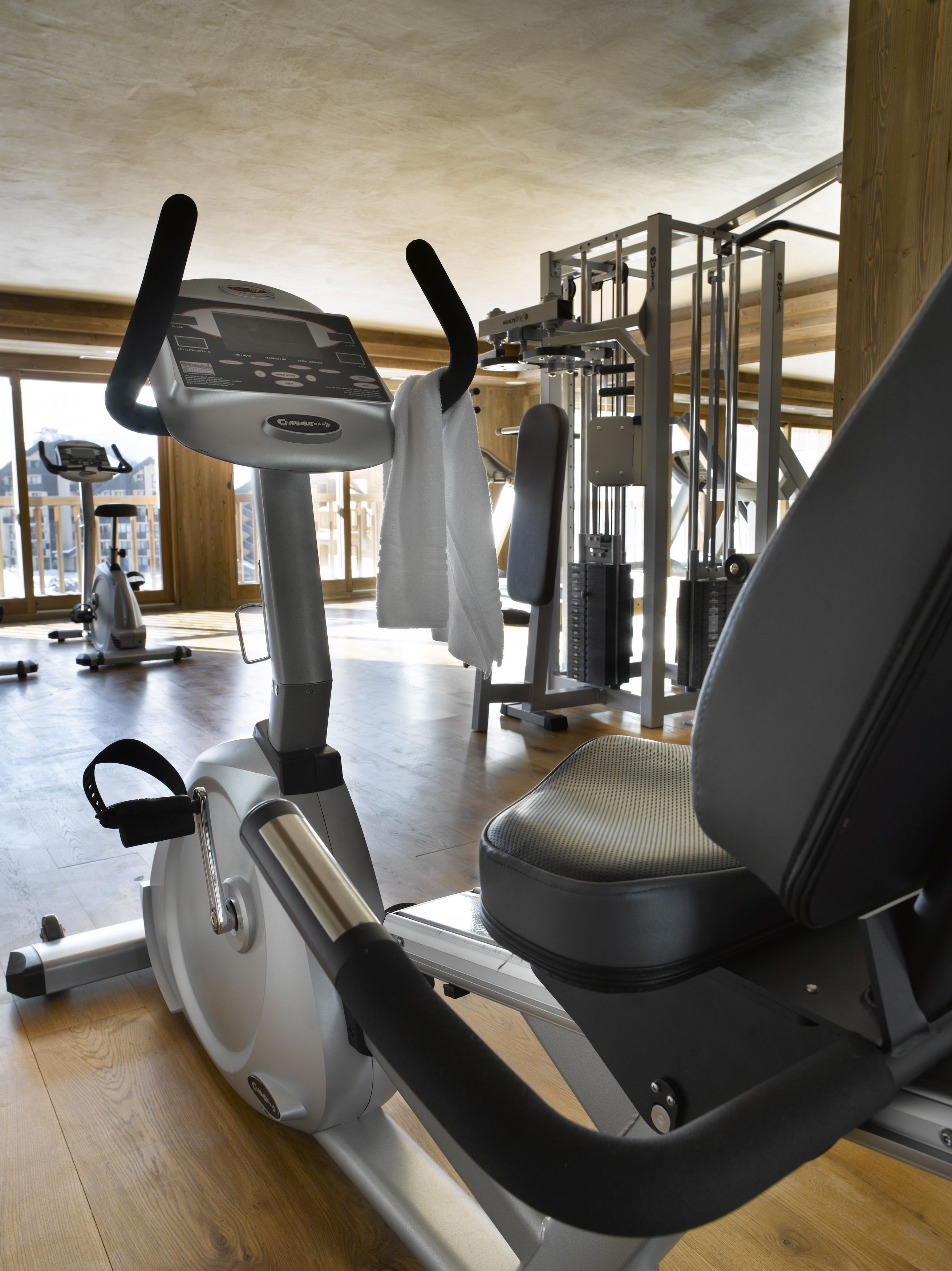 An indoor gym with exercise equipment, including an elliptical machine and a treadmill.