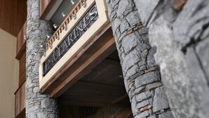 Portaikko, jossa on kivipylväät ja puinen kaide, johtaa tasanteelle, jossa on kyltti, jossa lukee: ”ESCLARINES”.