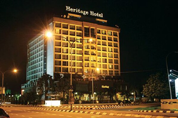 Heritage Hotel features a modern architectural design with a symmetrical facade.