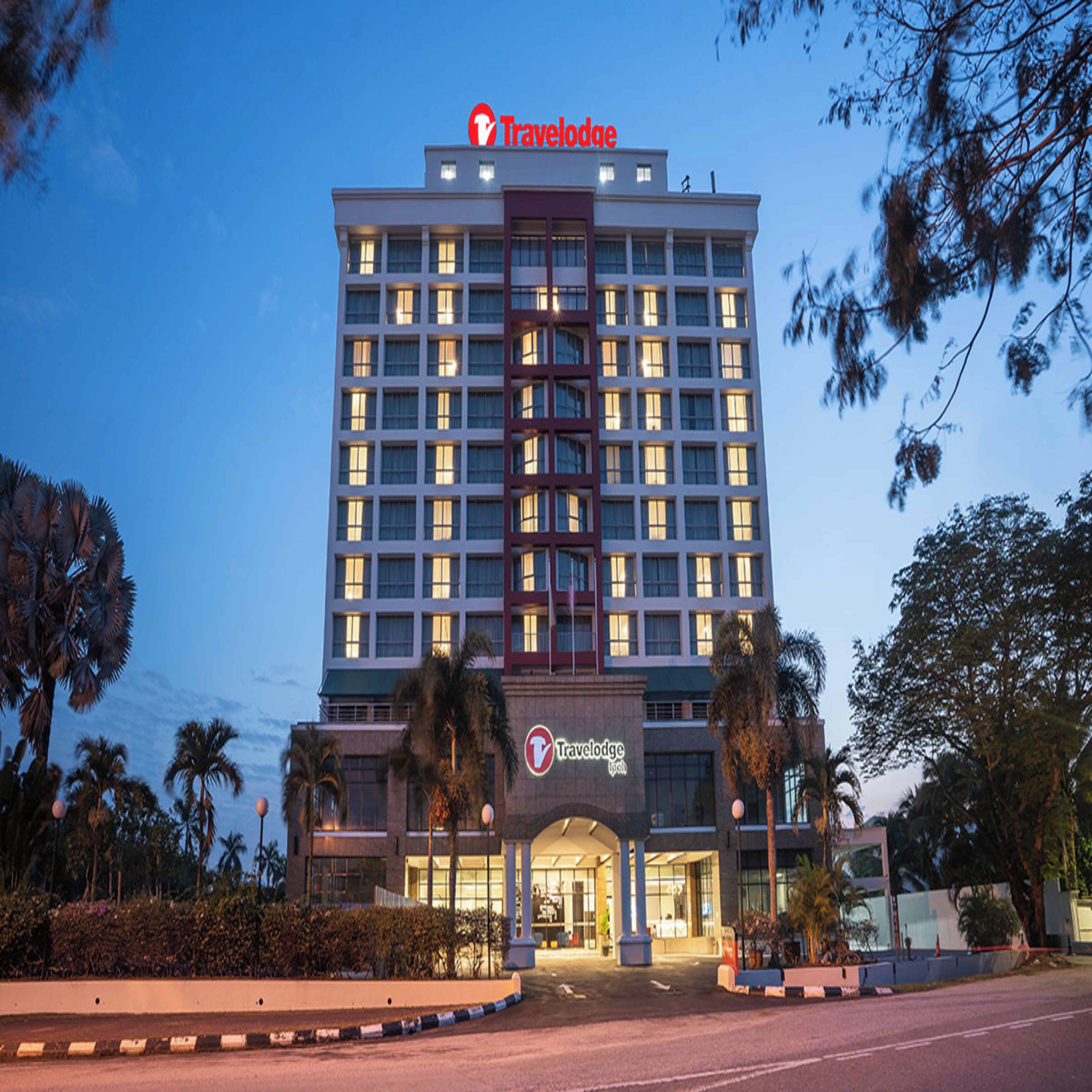 A Travelodge hotel with a modern facade, multiple floors, and a prominent entrance.