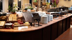 A buffet setup with various food items and a coffee station. - Heritage Hotel Cameron Highlands (Tanah Rata)