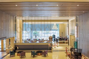A modern hotel lobby with a seating area, a reception desk, and a view of the outside. - Siam Mandarina Bangkok Suvarnabhumi Airport Hotel (Free Shuttle) (Bang Phli)