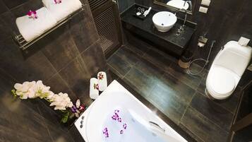 A modern bathroom with a bathtub, a sink, and a toilet.