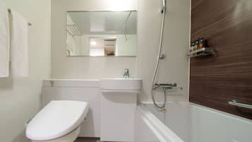 A modern bathroom with a toilet, sink, and shower.