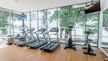 A gym with treadmills, elliptical machines, and a stationary bike.